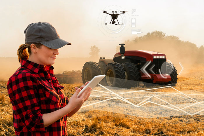 woman supervises smart tractor with 5g